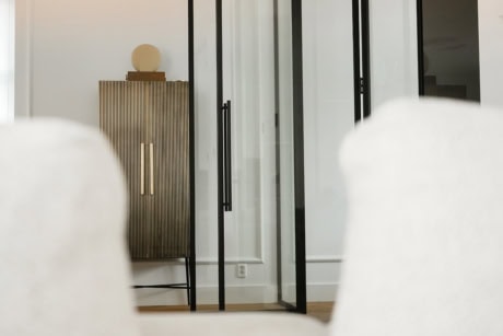 Hinged door with magnetic closure and a tubular handle.