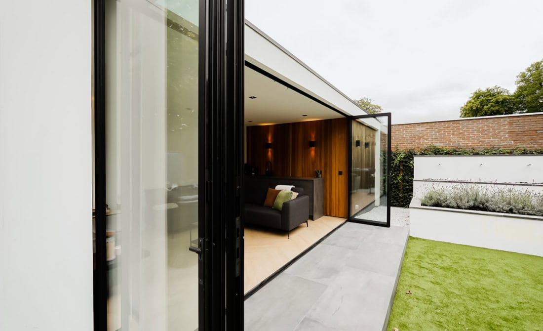 Bespoke black aluminium folding wall - effortlessly open for a seamless garden connection