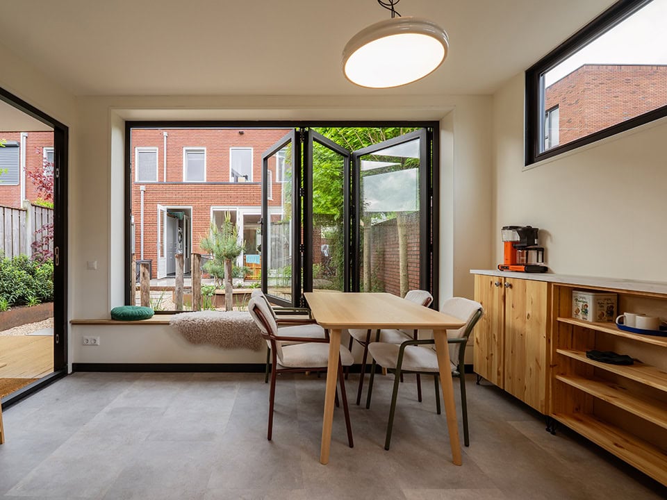 Modern steel garden door with large windows and French doors, perfect for a bright and open indoor and outdoor space, designed by Aluwdoors for customisation and quality.
