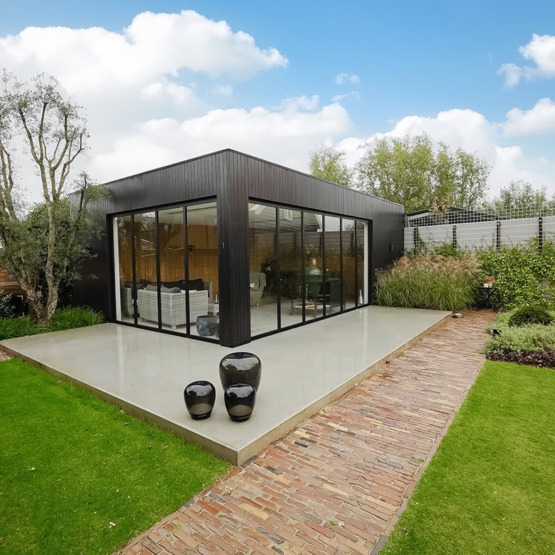 Bespoke modern black steel garden door and wall with large glass areas, sleek design and seamless connection to the garden, perfect for a stylish outdoor space.