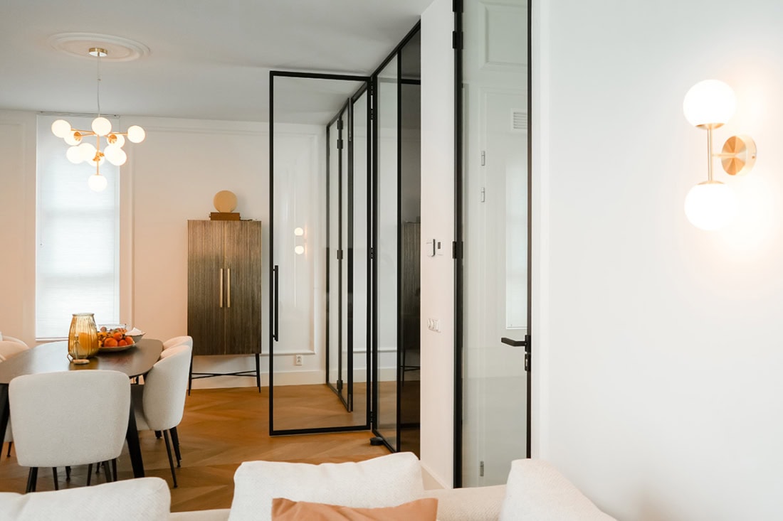 Glass wall and steel partition in modern interior, custom-made by Aluwdoors. High-quality steel doors and walls for a stylish partition.