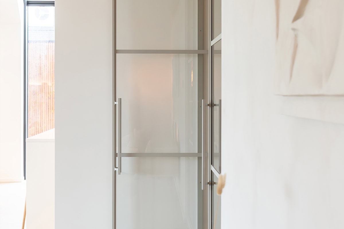 Sleek bespoke steel door and wall, minimalist modern design, durable finish, for a stylish interior finish.