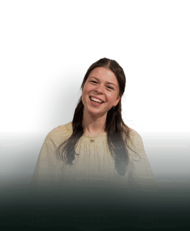 Smiling woman with custom-made steel door in the background.