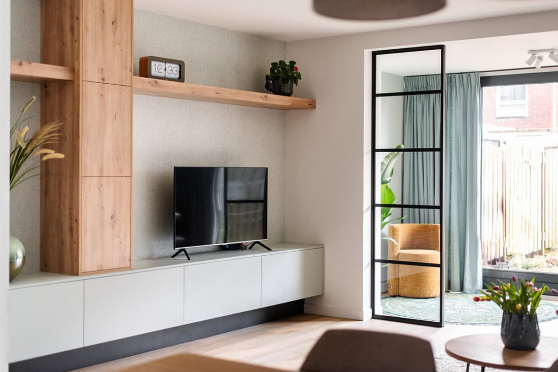 Gladys Rustic steel dividing door with black frame and large glass panels for modern interior design.