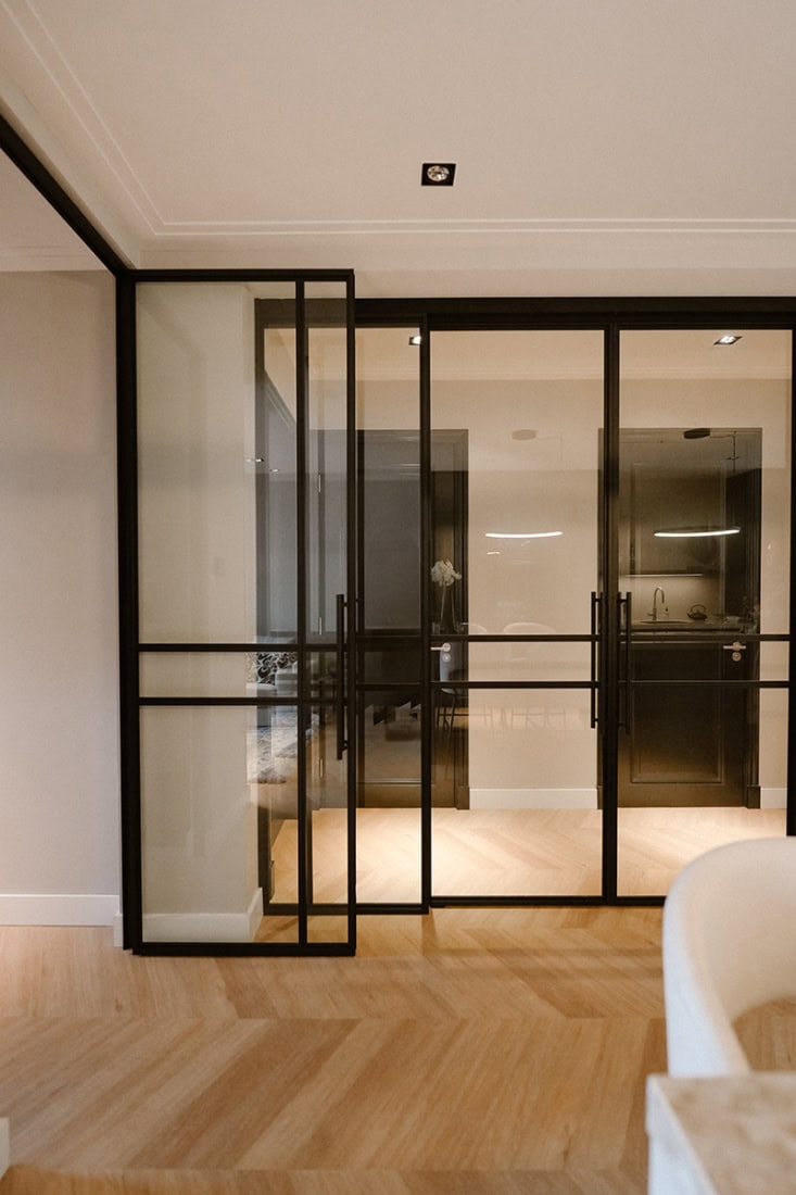 Elegant steel partition with black frame for modern interior division.