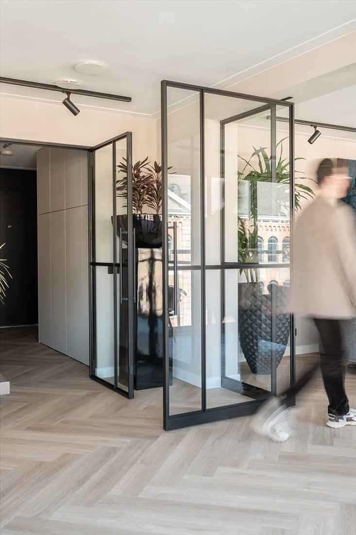 Stylised steel partition with glass panels for modern interior partitions.