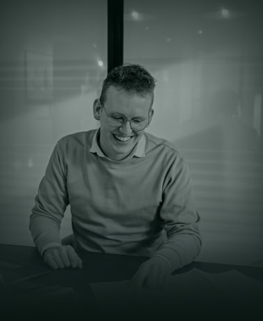 Elegant man reviewing documents in modern office represents professional service and customisation at Aluwdoors.