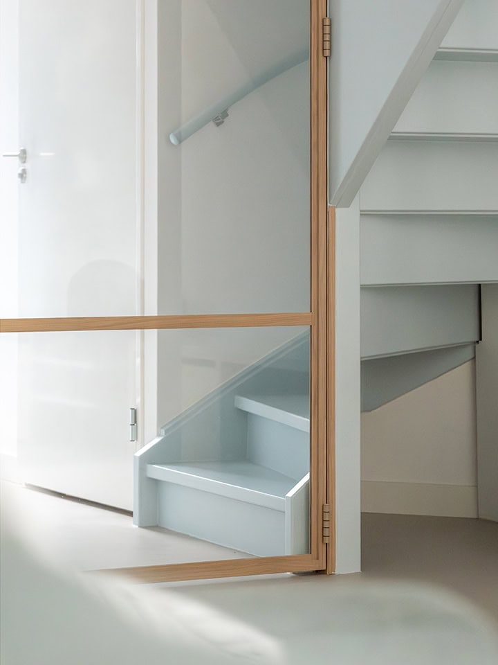 Modern steel door with glass panels and wooden frame, perfect for separating spaces in a home, matching the style of veneer doors.