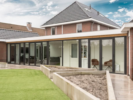 Aluminium buitenpui in Harderwijk met grote glazen panelen, perfect voor een strakke en moderne uitstraling van de woning. Op maat gemaakte stalen deuren en wanden voor een stijlvolle buitenruimte.