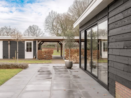 Aluminium external facade in Doornspijk with large glass panels and black finish, perfect for a modern and sleek look to the home.